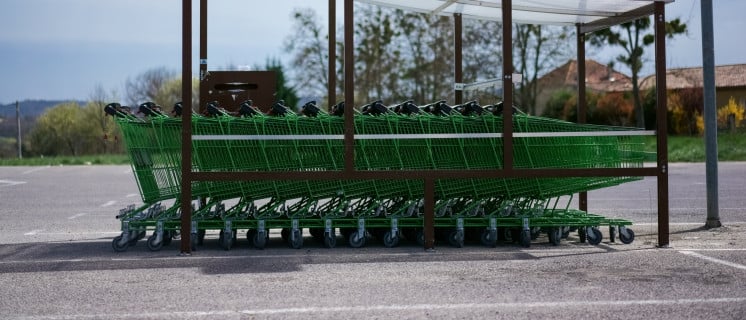Green shopping carts in front of a mall in Forcalquier, Haute Provence, France