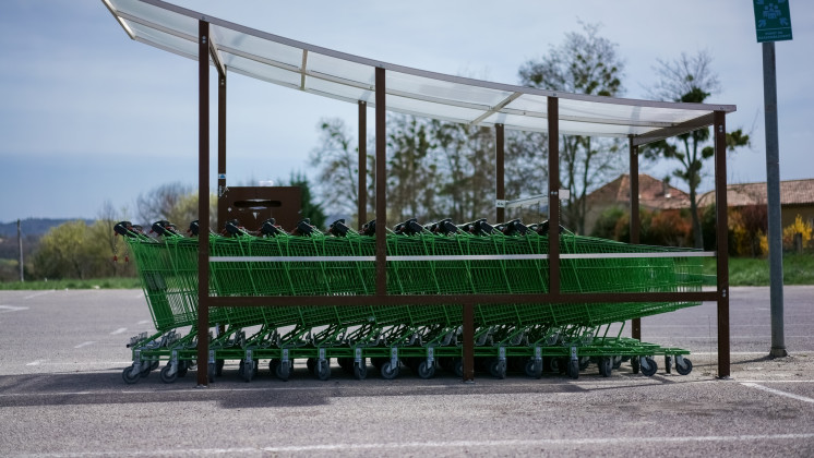 Green shopping carts in front of a mall in Forcalquier, Haute Provence, France