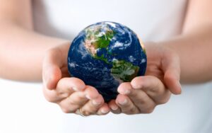 Image of a globe carried by two hands symbolising SOMO Services